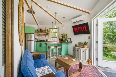[Living area] French doors open up into the spacious backyard. Sofa converts into a bed for additional sleeping space. 