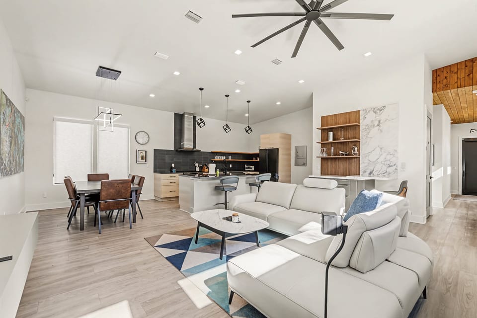 Bright open-plan lounge with sleek kitchen island and designer lighting