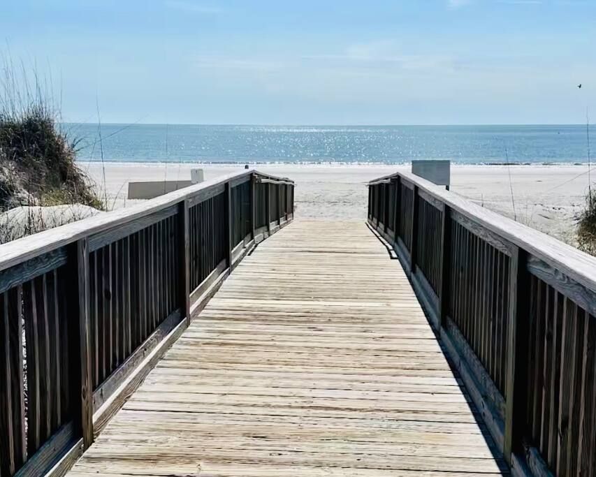 Your beach day begins here. Follow the scenic boardwalk through the dunes and arrive at miles of wide, uncrowded shoreline just steps from your villa. 

Morning walks, sunrise views, and sandy toes await just steps from your Villa.