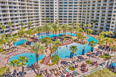 Expansive resort-style lagoon pool with multiple sections, bridges, and plenty of space to lounge and enjoy the sun.