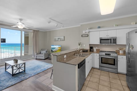 Bright coastal living area with private balcony and stunning Gulf views just steps from the beach.