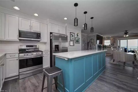Views of the bay while cooking dinner... it doesn't get much better than that. The open concept of this house has the kitchen flowing right into the living room so those cooking don't have to miss out on the views or the fun!