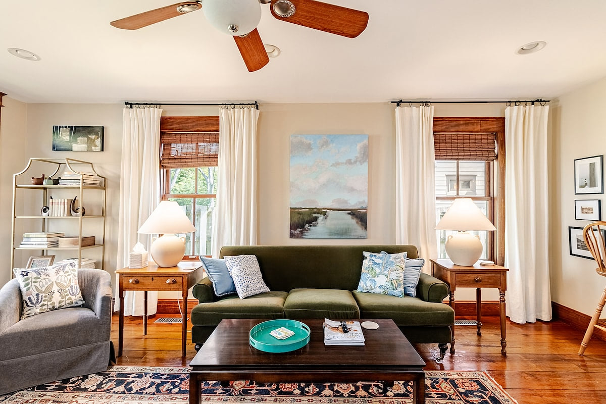 Stepping into our family room feels like entering a cozy art gallery! The antique pieces tell stories of the past, and the velvet sofa is so inviting. Curl up here for movie nights on the large screen TV.  It's the perfect blend of modern and cosy.