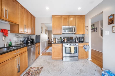 Modern kitchen with stainless appliances, coffee bar, and open flow.