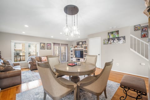 Bright open-plan living/dining with cozy seating and patio access
