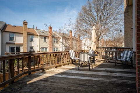 Sunny, spacious deck with seating and umbrella—perfect to unwind