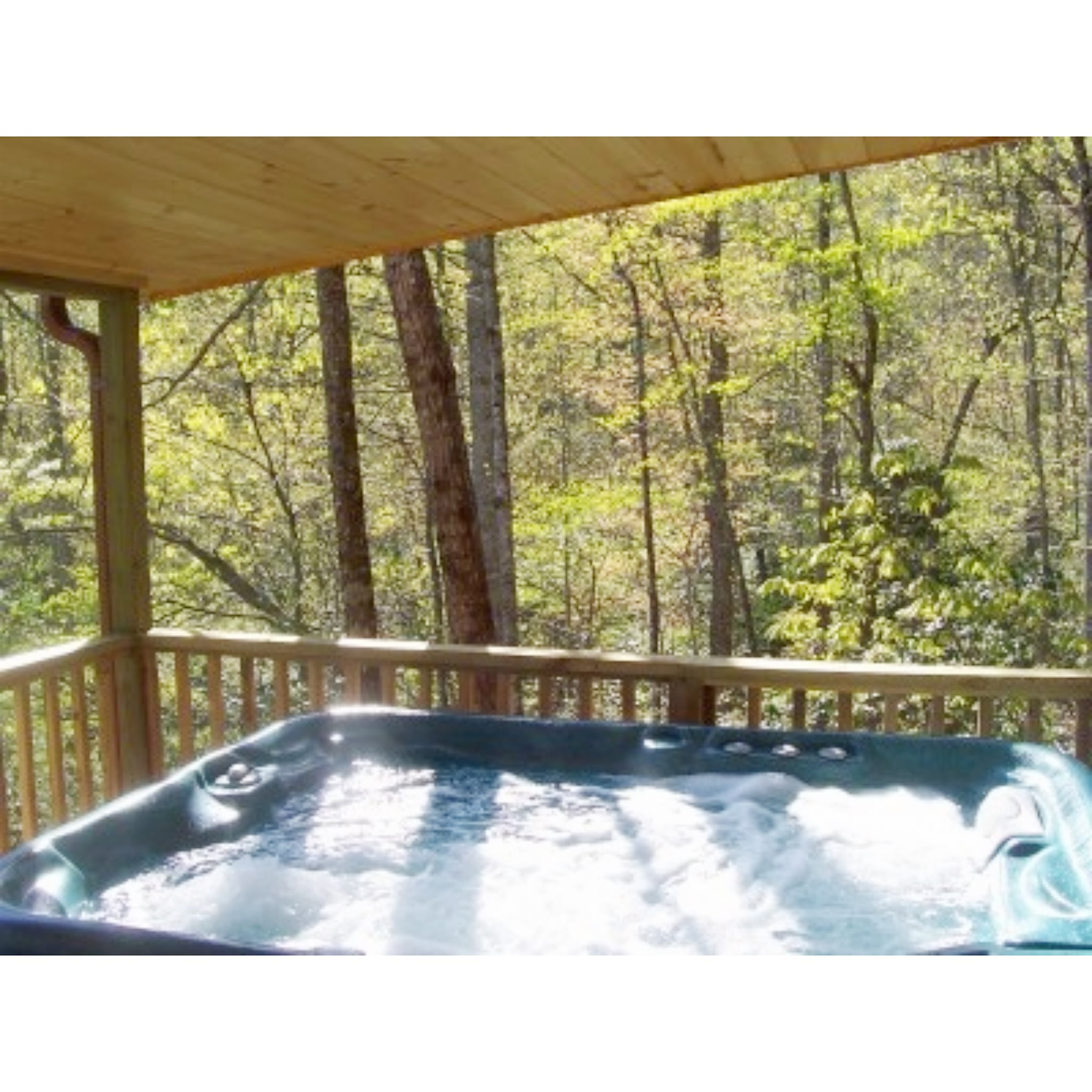 Your own private hot tub on the covered porch, screened by trees but just enough that you can still see the view..