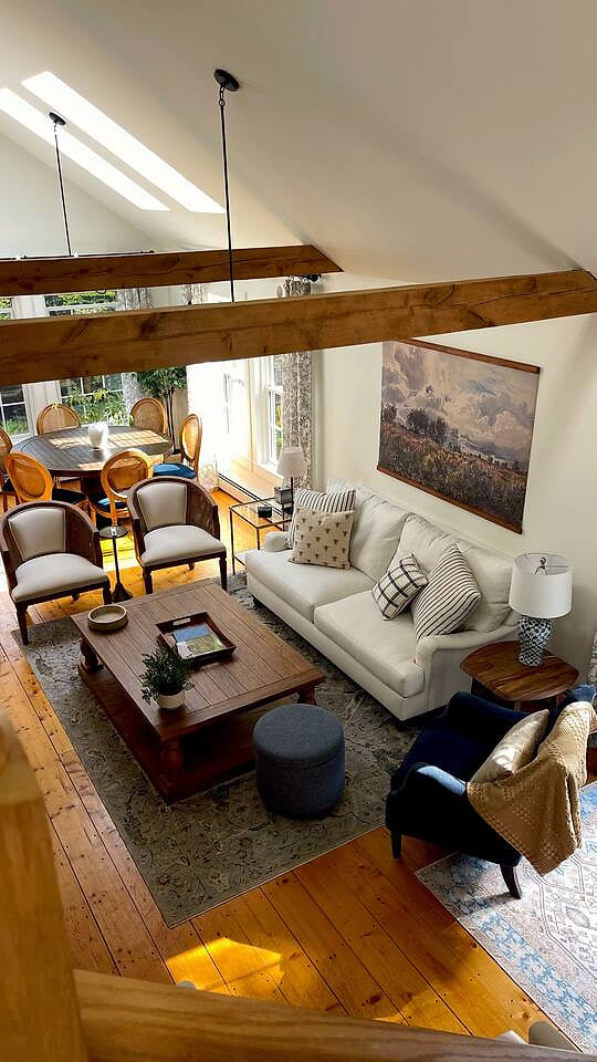 Enjoy casual conversations in this cozy living room that is flooded with natural light during the day. 
