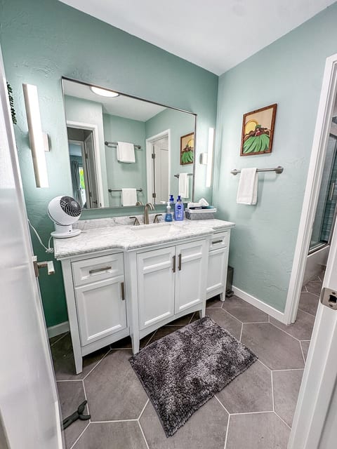 Separate powder room from main bathroom with ample light and fan.