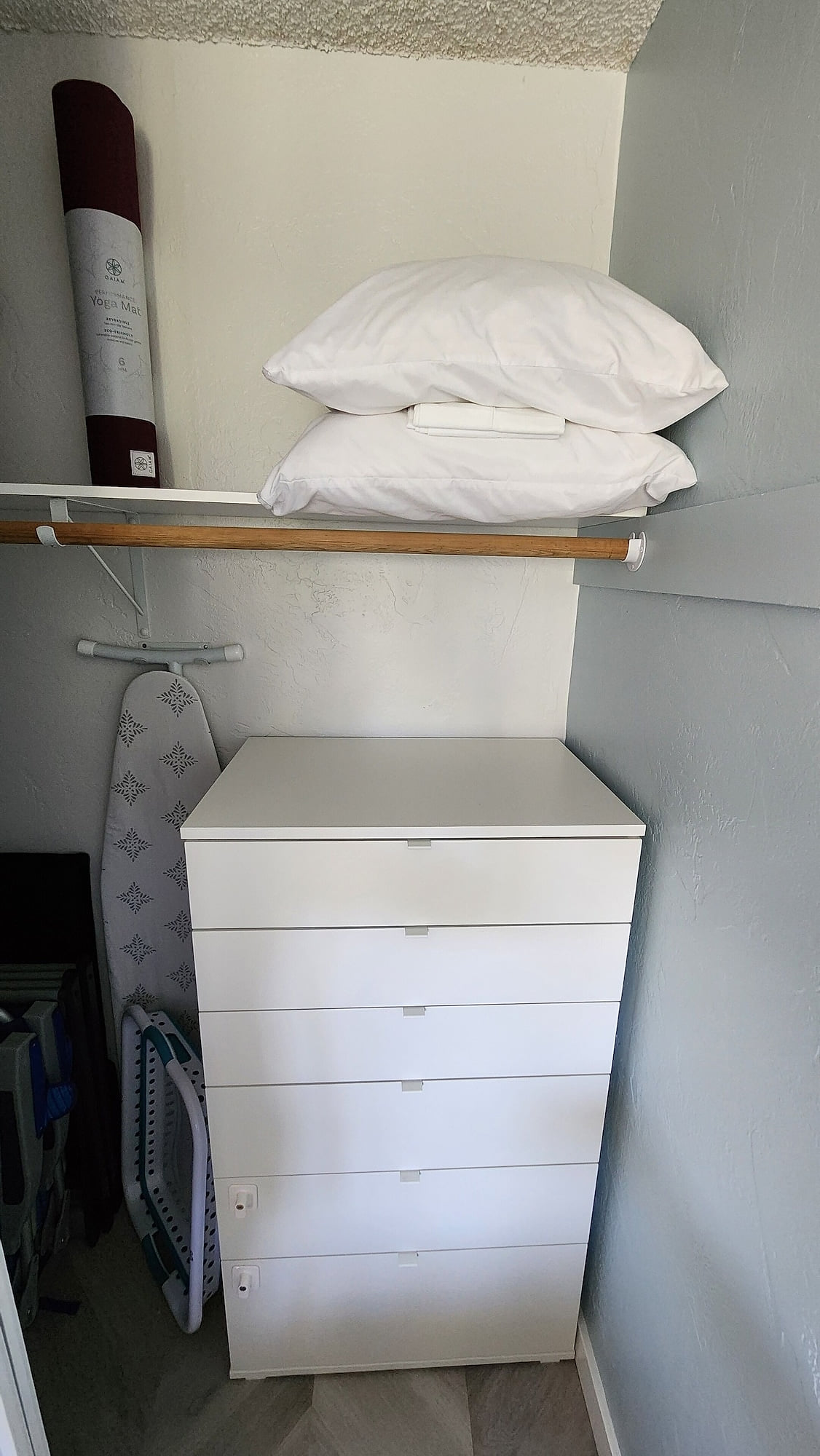 Dresser for your clothes, extra pillows, and yoga mat to use