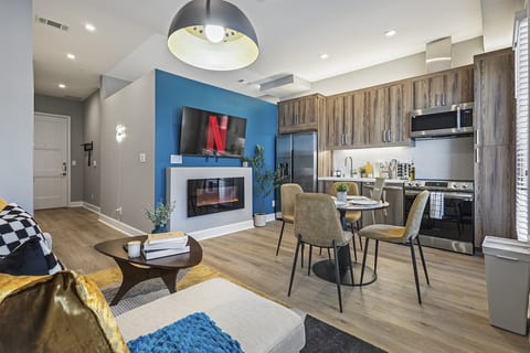 Bright and spacious open-concept living area with a cozy fireplace.