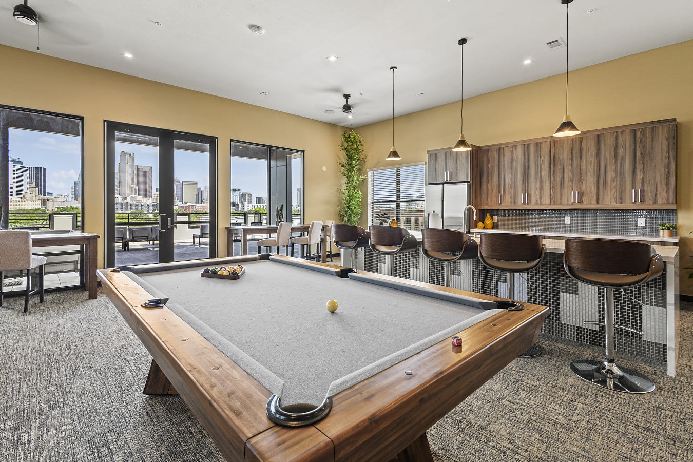 This community space features a stylish pool table.