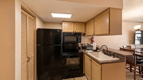 Kitchen with full size range and refrigerator