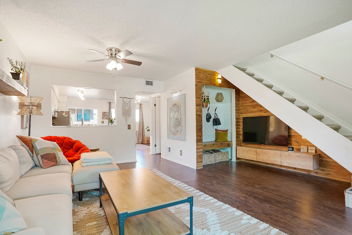 Main living room with fireplace, mudroom and cozy TV area.