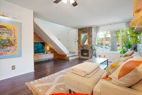 Main living room with fireplace, mudroom and cozy TV area.