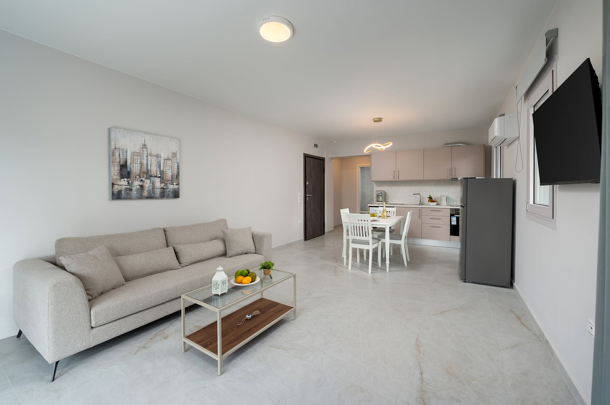 Bright open-plan living with sleek kitchen, dining for 4, TV & AC.