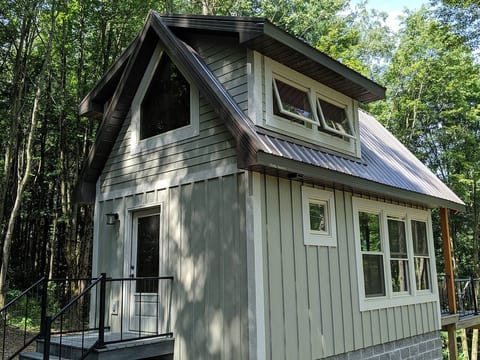 An outside view of the sleeping loft.  LOTS of windows so you feel like you are in the trees.