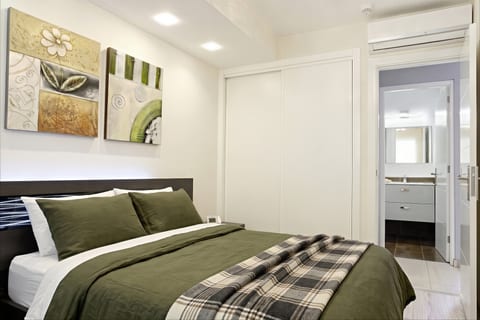 Modern bedroom with ensuite, AC, and built-in wardrobe—sleep in style.