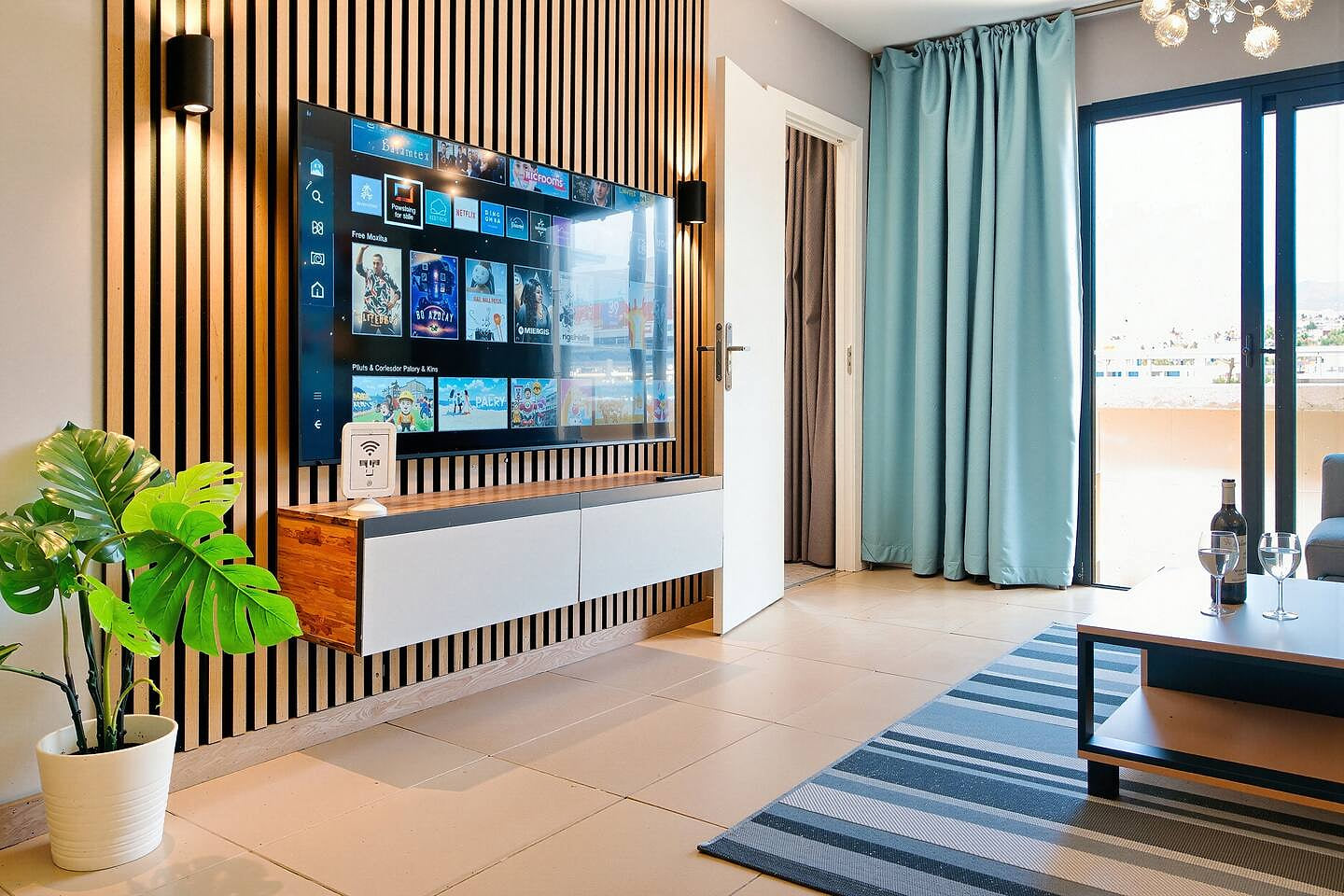 Bright and airy living room with large sofa, Smart TV, and sound system—perfect for relaxing after a day at the beach.