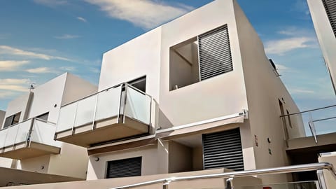 Modern condo with private glass balconies and sleek sun-shaded design