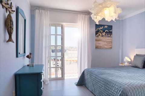 Airy coastal bedroom with balcony and sea view, serene and bright