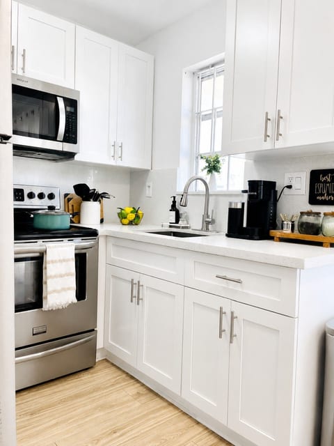 Bright, modern kitchen with quartz countertops, shaker-style cabinets, and all the essentials to make your stay comfortable.