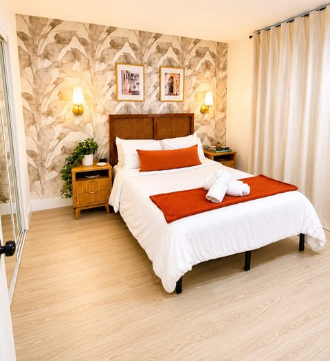 Inviting guest bedroom with a full-size bed and tropical-inspired décor designed for a restful stay.