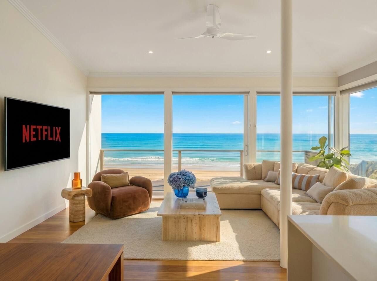 Floor‑to‑ceiling windows frame uninterrupted ocean views. Sink into the plush sofas and let the natural light and sea breeze wash over you as waves roll in just beyond the glass.