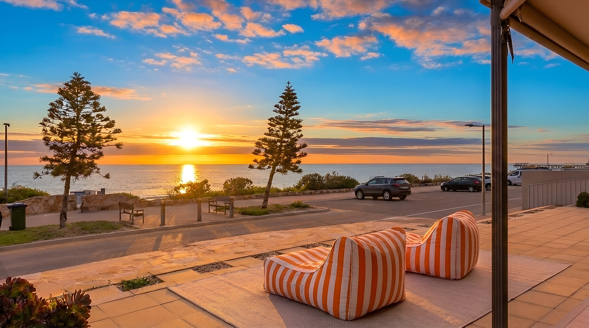 Sunset-facing terrace with ocean views and stylish outdoor loungers