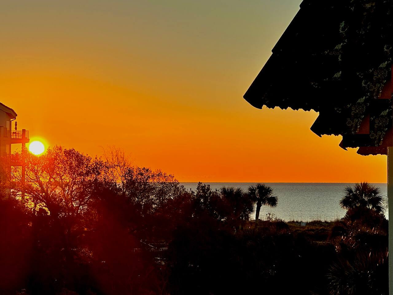 Enjoy coastal marsh and ocean views from the balcony!
- straight ahead and to the left: serene Lowcountry Marsh
- to the right: a view of the ocean.

( Sunrise photo taken from balcony)
