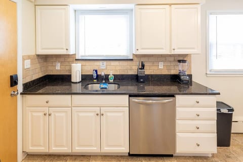 Fully stocked kitchen with dishwasher and stainless steel appliances