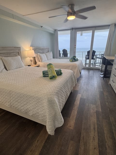 Two queen beds with private balcony and stunning oceanfront views