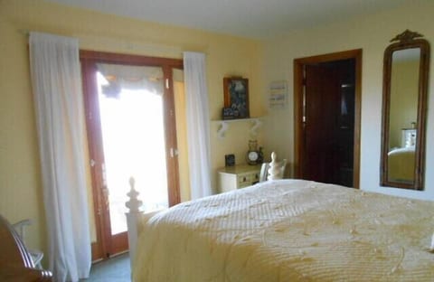 Bedroom 2 with private entrance, walk in closet and queen bed.