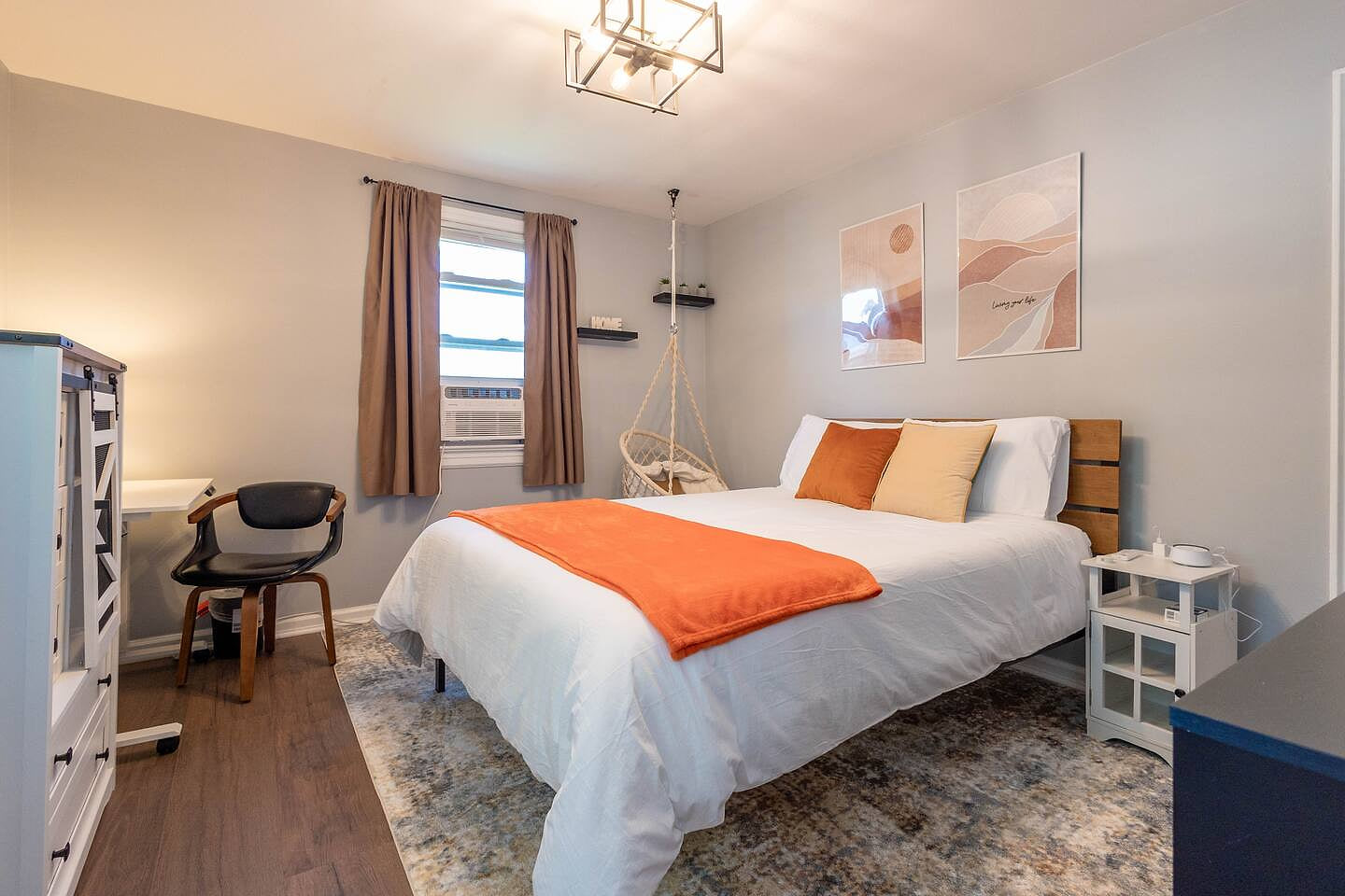  Comfortable bedroom with a dedicated workspace and cozy reading corner.