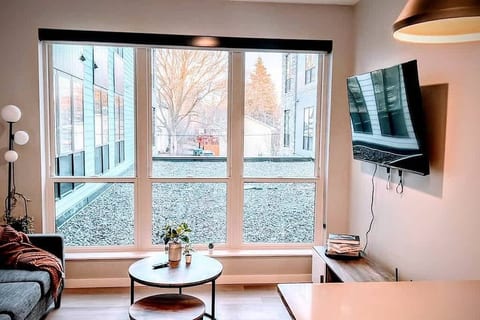 A cozy modern retreat with big windows, natural light, and sleek decor. Relax & unwind!