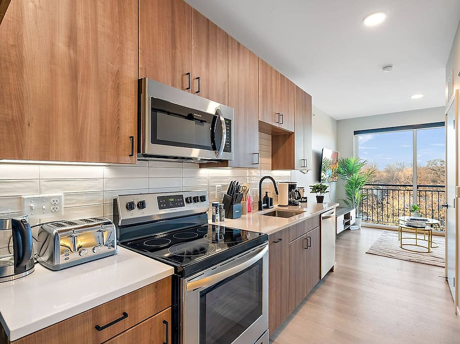 Stylish kitchen with wood cabinetry, modern appliances, and a cozy open layout.