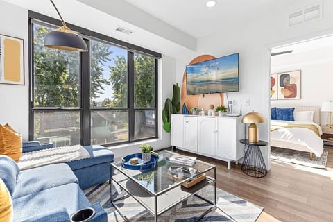 Bright, modern oasis with chic decor, smart TV, and cozy bedroom for ultimate comfort.