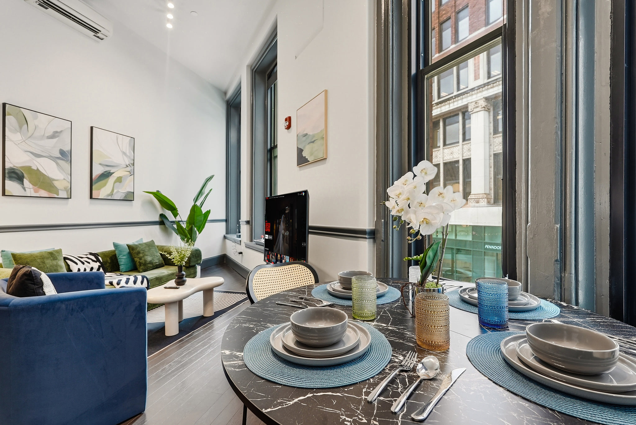 Stylish loft with soaring ceilings, large windows, and a chic dining nook