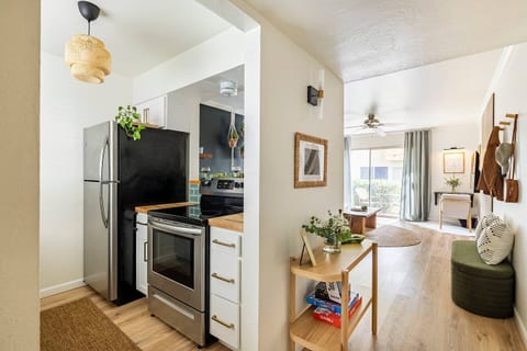 Galley kitchen with window through to dining and living area