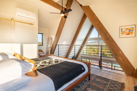 Lofted bedroom area with king bed