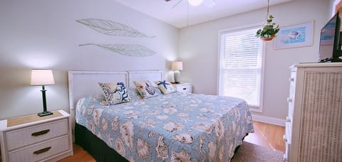 King bed in bedroom with small tv