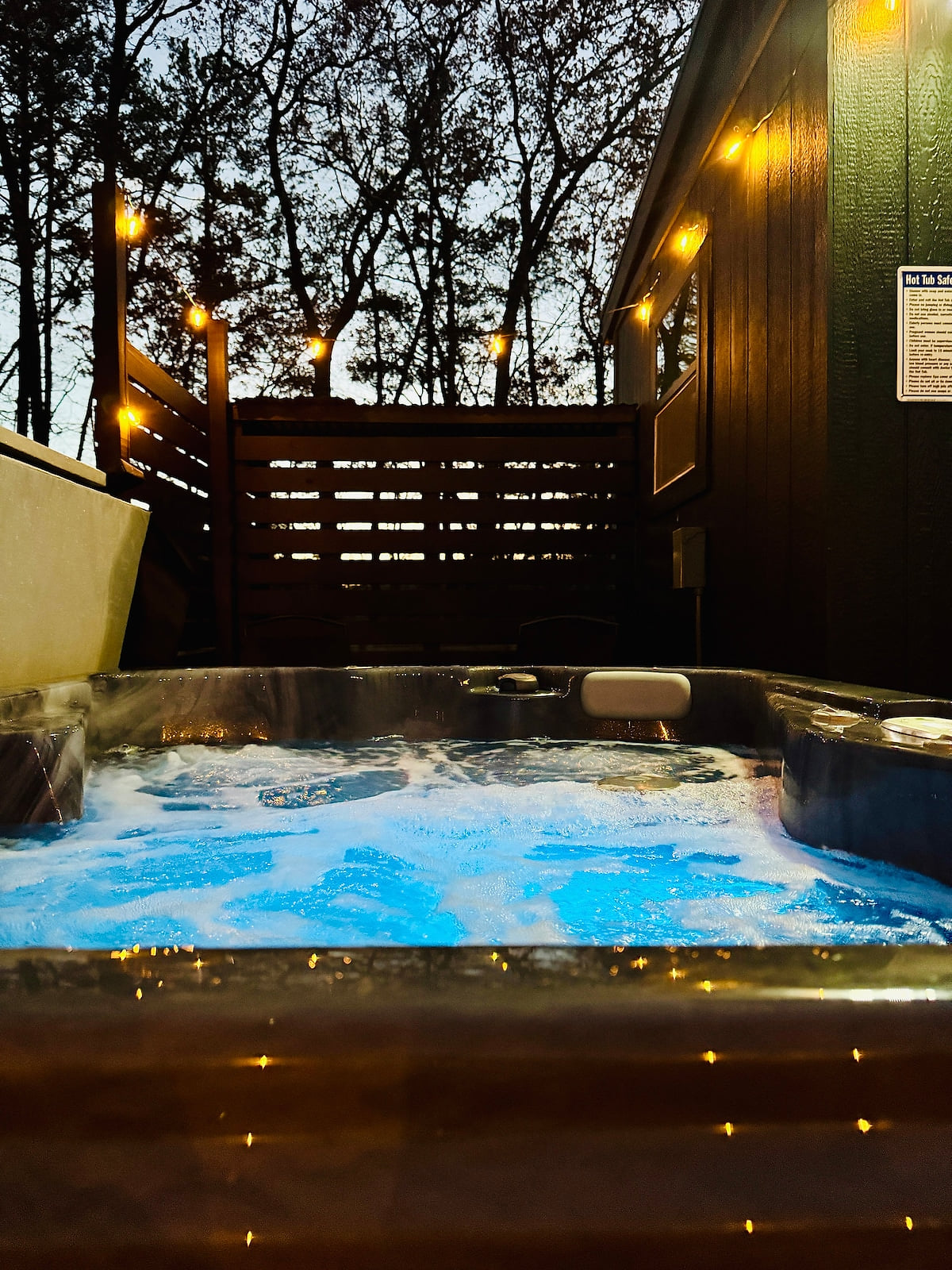 Your private hot tub glowing under the stars — available 24 hours, all year round