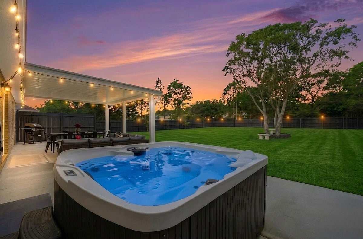 "Picture this: A six-person hot tub, a covered patio, and glowing bistro lights under a sky on fire. This is your perfect Navarre sunset—and the ultimate Florida evening is just one click away. Book your stay now."