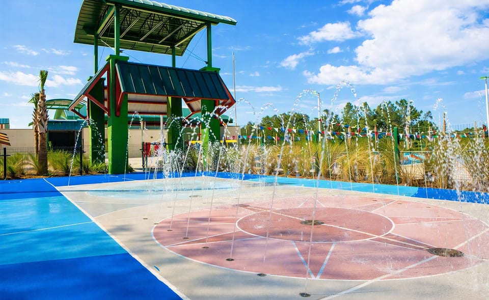 Resort-style splash pad with water jets and shaded pavilion fun