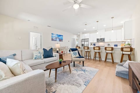 Spacious living room designed for together time—gather for games, unwind with a movie on the 65" TV, or settle in on the fold-out couch. Furry companions welcome, with a cozy pet bed included for their comfort.