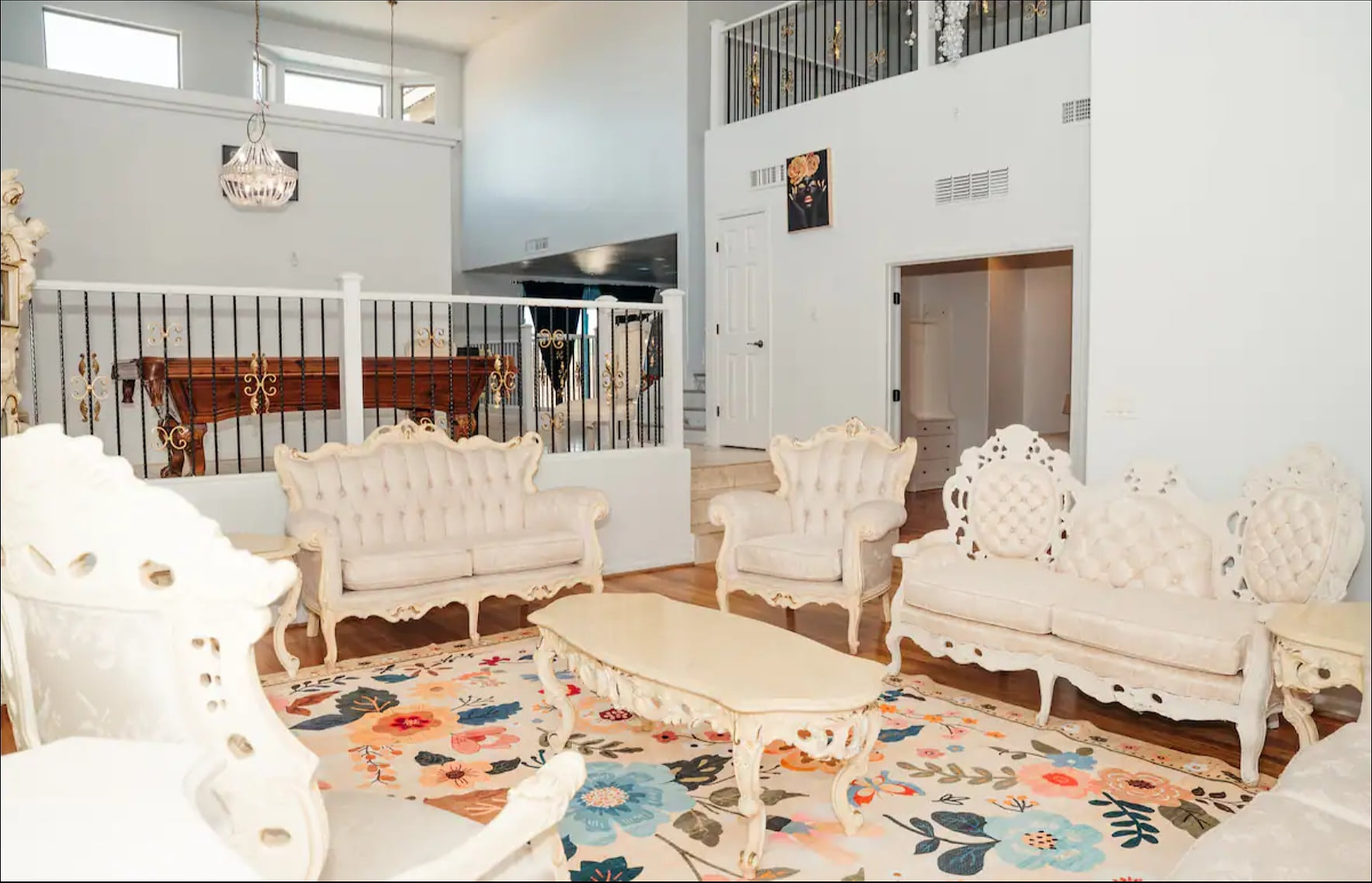 Elegant lounge with soaring ceilings, ornate seating, and bright open space