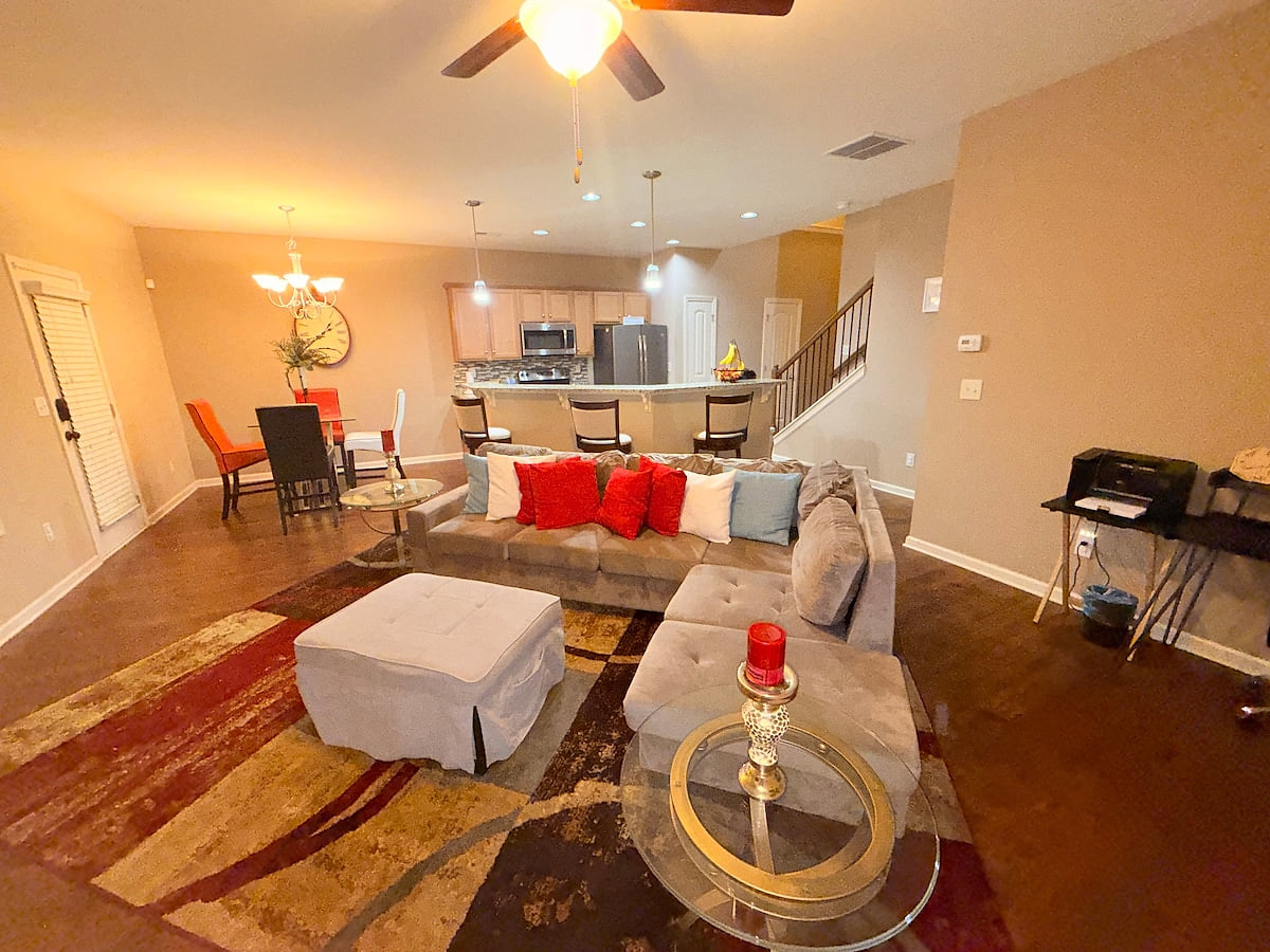 Cozy entertainment corner featuring a mounted smart TV above a classic fireplace. Styled with simple décor accents this space creates the perfect spot to relax, watch your favorite games, or unwind with a game of Jenga. 
