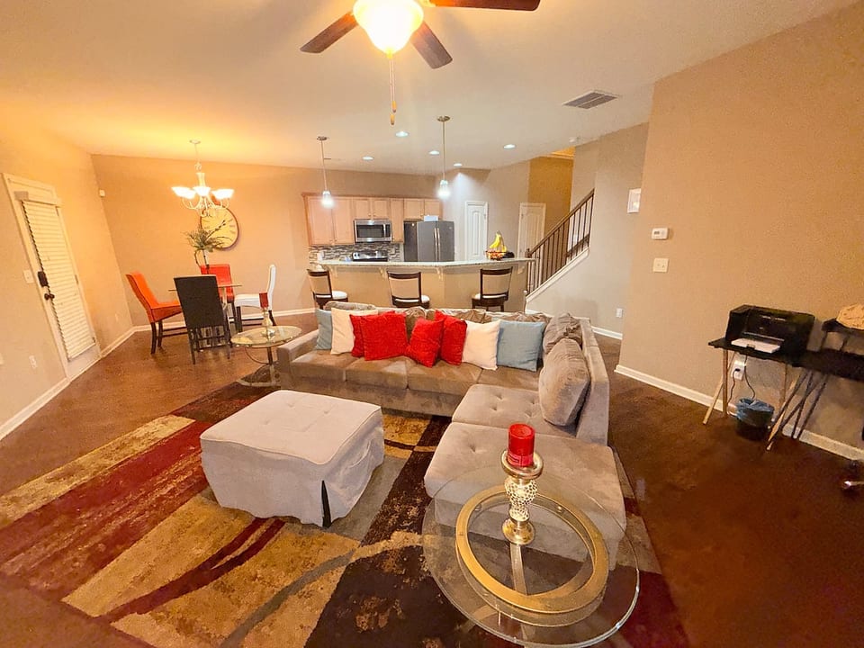 Cozy entertainment corner featuring a mounted smart TV above a classic fireplace. Styled with simple décor accents this space creates the perfect spot to relax, watch your favorite games, or unwind with a game of Jenga.