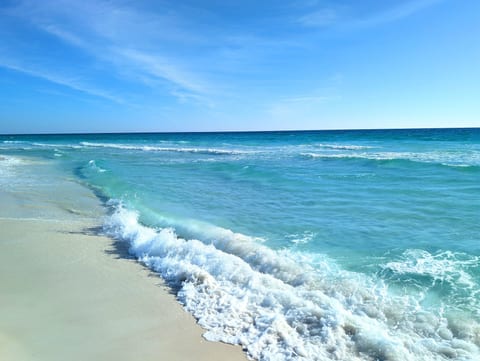 Steps from a stunning turquoise beach with soft sand and gentle waves
