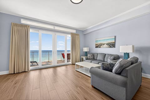Spacious living area featuring a queen-size sleeper sofa and cozy beach-inspired décor.